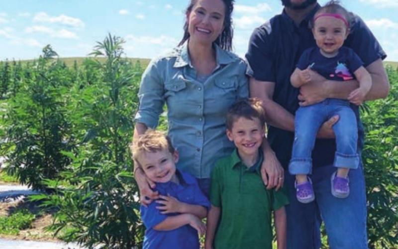 Shane and Cathy Weber and their kids (L-R) John, Reid and Allie in their hemp field last summer.