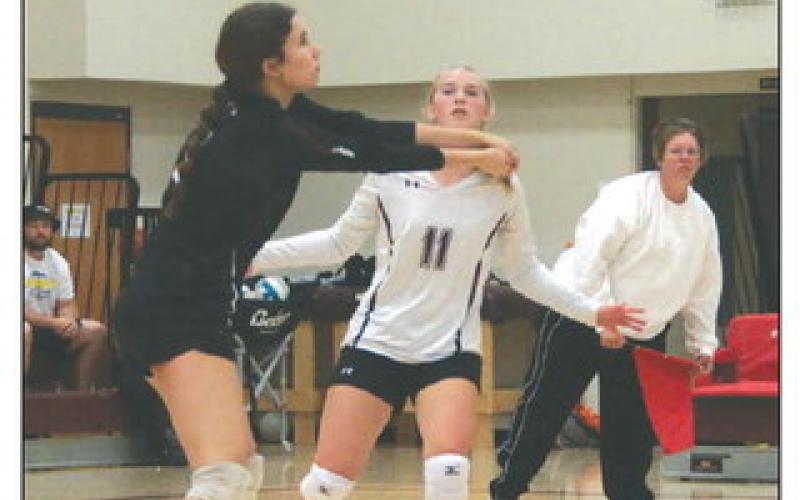 Natalie Lawrence hits a bump shot while teammate Averie Marshall (11) looks on during Lady Panther volleyball action against Dupree last Thursday, Sept. 14. Photo by Jon Flatland