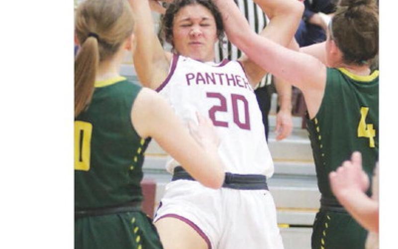 Sophomore forward Jasmine Nash (20) is fouled while pulling down a rebound during action against Aberdeen Roncalli last Friday, Jan. 27. The visiting Crusaders upset the No. 4 ranked Lady Panthers 62-49. Photo by Jon Flatland