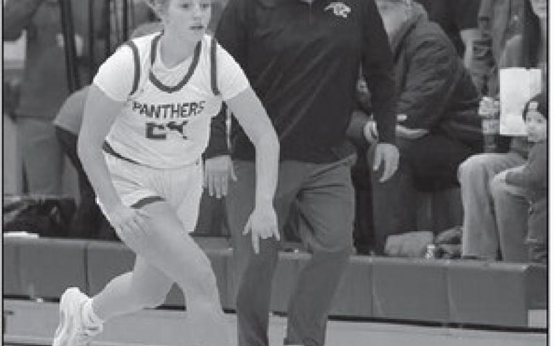 Maddy Hermes brings the ball upcourt while Timber Lake coach Tuffy Thompson gives her instructions during Panther basketball action against new Underwood. Topic Photo/Marie DuPreez