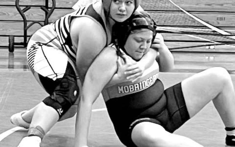 McLaughlin-Timber Lake’s Lilly Veit (left) looks for direction from the Mustang coaching staff while locked onto Mobridge-Pollock’s Tatum Silbernagel during the Girls 176-185 pound championship at the Potter County JV Tournament in Gettysburg on Monday, Dec. 4.