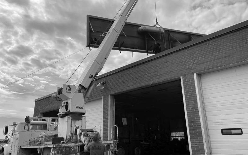 Perry Keller, Joe Martindale and Kyle Tesch of Keller Trenching, along with Albert Keller of Keller Drilling, removed the old solar panels from the roof of the Isabel City Shop last week as part of a re-roofing project. The flat roof is being replaced by a pitched roof.