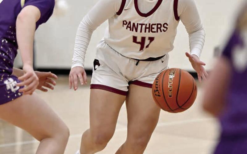 Eighth grader Madalyn Hermes looks for an opening in the Harding County defense to drive the lane during Timber Lake's battle with the Ranchers last week. The Lady Panthers were upon the Ranchers early, but unbeaten and state-ranked Harding County battled back for the win.