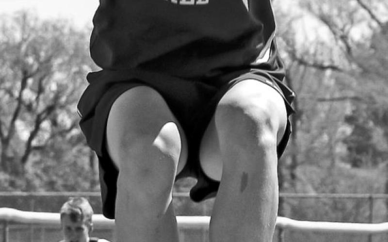 Brayden Terveen of Dupree lifts off during the triple jump event at the region track meet. Photos by Jon Flatland and Robert Slocum