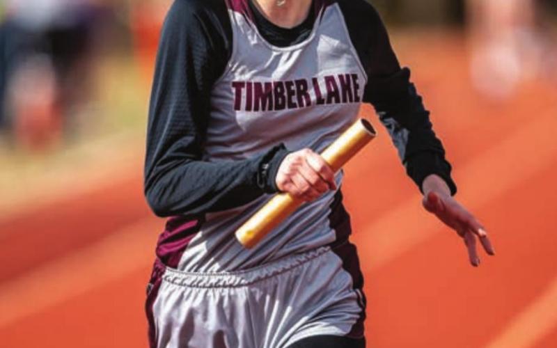 Natalie Biegler races down the track in a relay race. She and the TL girls placed second in the conference meet.