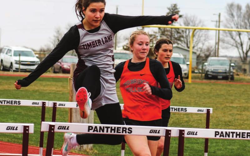 Abby Linderman leaps over a hurdle