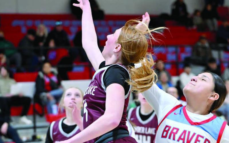 Junior Sara Keller lays a shot up while being defended by Koree Buffalo Halfrib of Cheyenne-Eagle Butte during the Lady Panthers’ loss to the Braves last week (see Page 9). Timber Lake took on Faith in the first round of the Region 8B Tournament on Tuesday evening as this issue of the Topic was going to press. Photo by Marie DuPreez