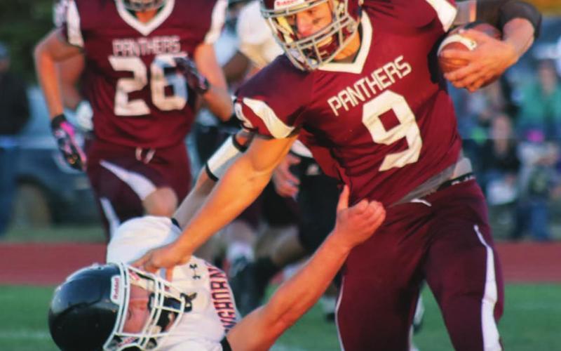 LEFT: Timber Lake running back Hank Kraft stiffarms a Faith Longhorn defender during a run on Friday night in the Panthers’ home opener. Kraft caught three touchdown passes and ran for another in the 64-14 victory.