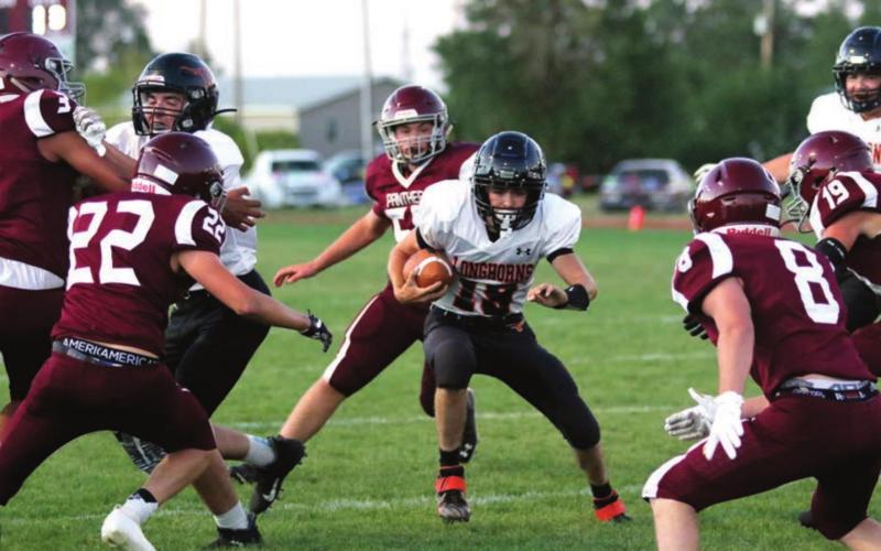 BELOW: The Panther defense swarms Faith ball carrier Toarin Humble during their game Friday in Timber Lake. Photos by Jon Flatland