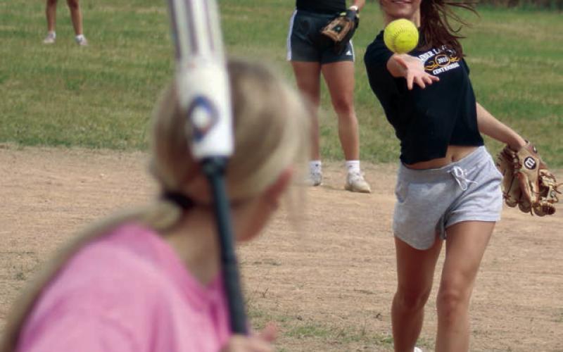 Natalie Gross pitches for her team. In back are Manuela Molinera (former Timber Lake High School exchange student) and Shay Kraft.