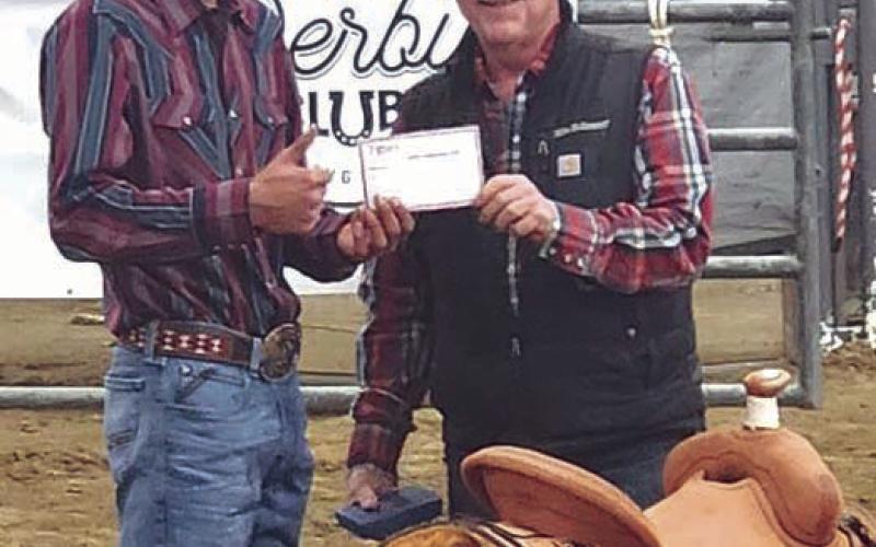 Chazz Gabe of Timber Lake accepts a saddle for winning the bull riding at the NRCA Rodeo in Gillette, WY, last weekend. Gabe also snagged a championship buckle for winning the NRCA season standings.