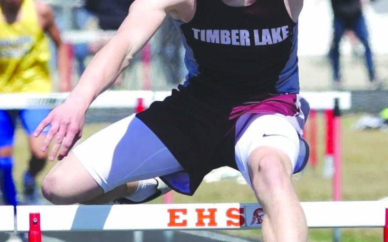 Gracen Hansen wears a face of determination as he clears a hurdle during recent competition. Hansen won the 300 meter hurdles at the Eureka Lions Club Meet last week and will vie for a Little Moreau Conference title on Thursday, May 11 in Lemmon. Photo by Mary Farlee