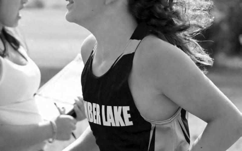 The signature long locks of Timber Lake seventh grader Mason Kraft (right) were blowing in the breeze last Thursday at the C-EB Cross Country Invitational. Kraft, competing in his first varsity race, posted a time of 22:19.00 to land 17th overall. Photo by Jon Flatland