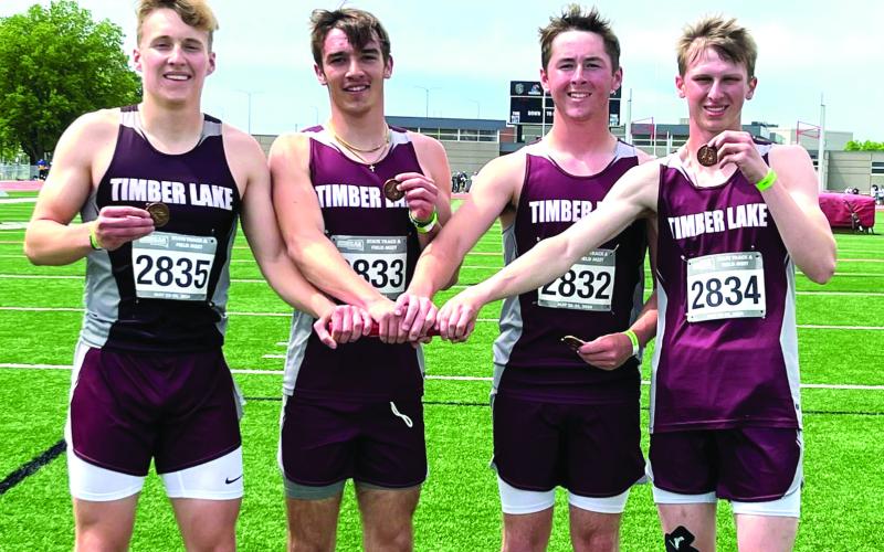 The TLHS 1600 meter relay team of (l-r) Gracen Hansen, Gavin Farlee, Cole Ducheneaux and Holden Gill show off their third place bronze medals at the South Dakota State Class B Track Meet last week. The foursome shattered the school record in the event, which they set two weeks ago at the Super Region Meet, by shaving more than four seconds off their time. Submitted Photo