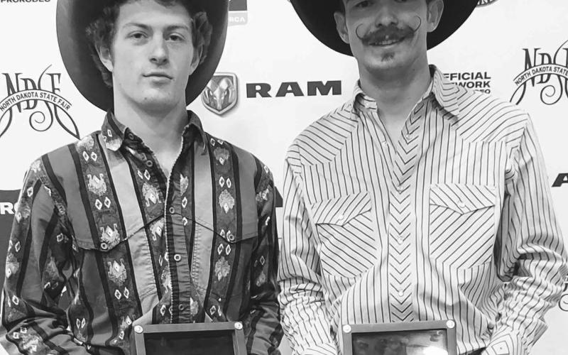 Chance Schott, right, of McLaughlin won the average championship in bull riding at the 2022 PRCA Badlands Circuit Finals Rodeo in Minot, Friday through Sunday, Oct. 14-16. In each of the four years he’s qualified for the rodeo, Schott has won either the year-end title or the average championship. At left, Jestyn Woodward of Custer claimed the circuit’s year-end bull riding title. Photo courtesy of Badlands Circuit Finals Rodeo