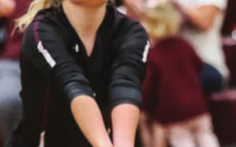 Bailey Keller fields a serve in recent varsity volleyball action.