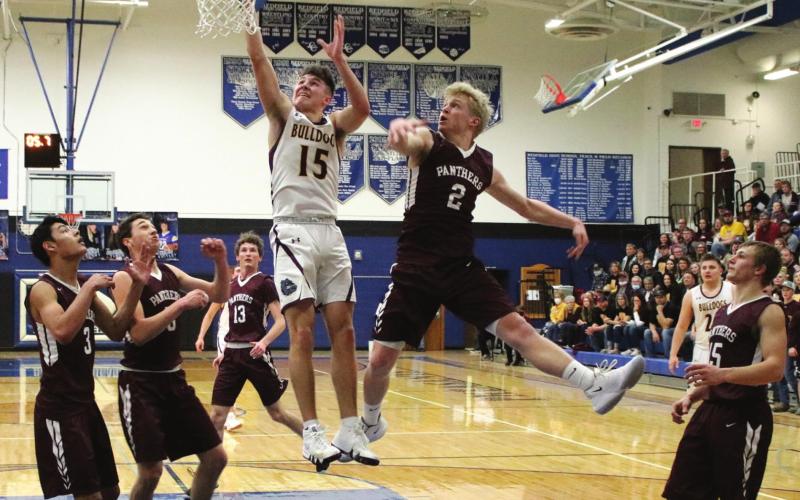 Timber Lake players (L-R) Chazz Gabe, Trenton Hansen, Hunter Schrempp, Brady Sandquist and Hank Kraft watch as De Smet’s Kalen Garry (15) drives to the basket. Photo courtesy of Mike Siefker, Kingsbury Journal