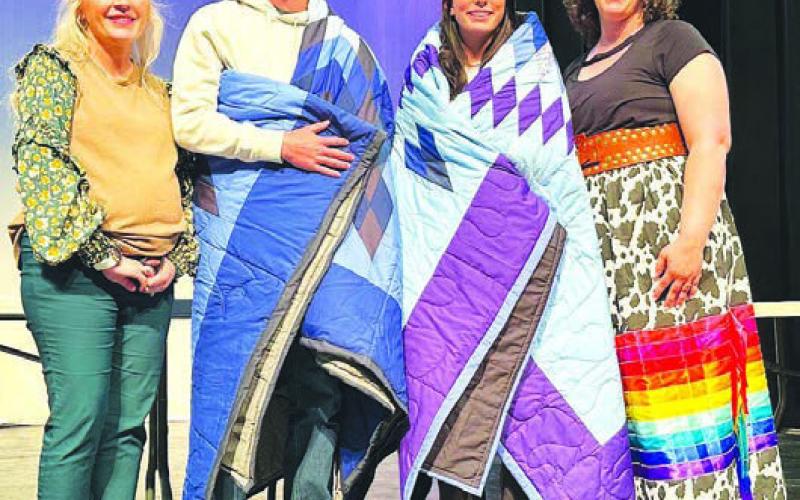 Cole Ducheneaux and Mckenzi Vomacka (middle) received star quilts and $2000 scholarships in memory of Jim O’Leary at the TLHS Awards Day. Making the presentation were Jim’s sister, Laura O’Leary Rose (left), and his widow, Megan Simon O’Leary (right). The award honors a student who demonstrates the character traits of the late Jim O’Leary. There were ten applicants for the two scholarships awarded.