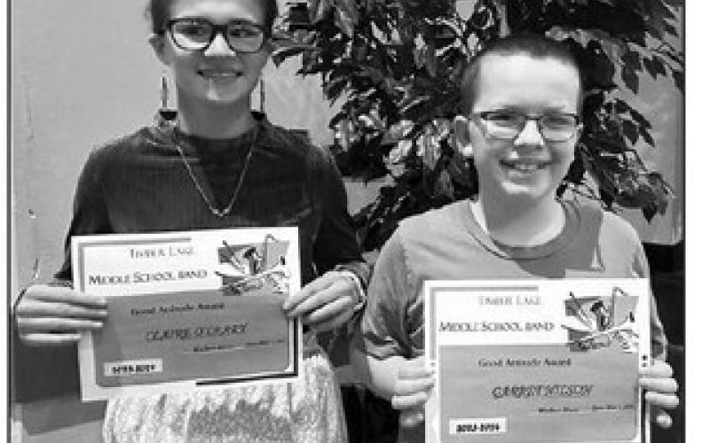 Claire O’Leary (left) and Garrett Nilson received the Good Attitude Award from music teacher Walker Rose.