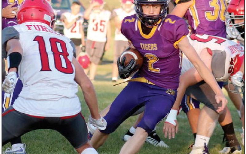 A wide-eyed Cruz Birkeland (2) puts a move on a Potter County defender during the Dupree Tigers 56-6 win over the Battlers at Tiger Field last Friday, Sept. 13. Birkeland, a junior running back and linebacker, had a career day, scoring five rushing touchdowns and a defensive TD when he scooped up a blocked Potter County punt and took it into the end zone. Photo by Jon Flatland