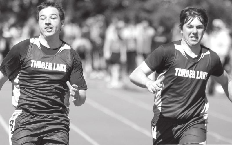 Timber Lake’s Dan Peterson (L) and Konor Lindskov race down the track in the 100 meter dash.