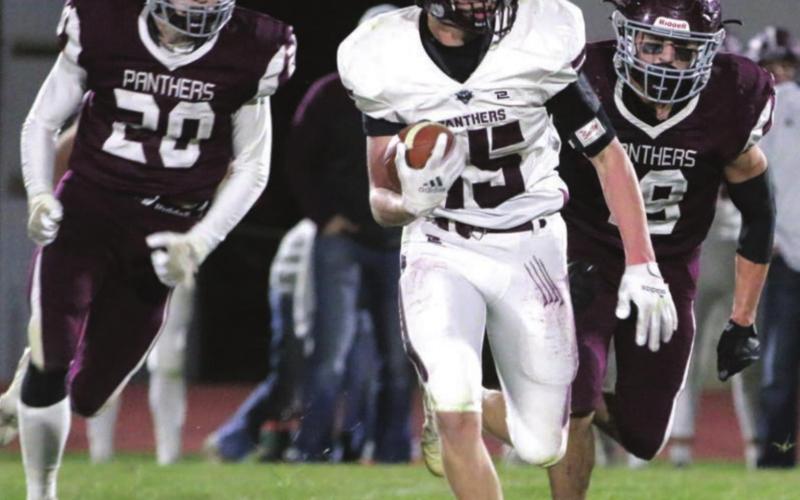 Timber Lake defenders Thane Keller (20) and Jayce Lawrence (19) chase a Platte-Geddes ball carrier during their state semifinal football game in Timber Lake. Photos by Jon Flatland