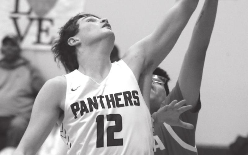 Timber Lake senior Dixon Booth snares a rebound during Region 8B play versus Tiospaye Topa. Photos by Jon Flatland