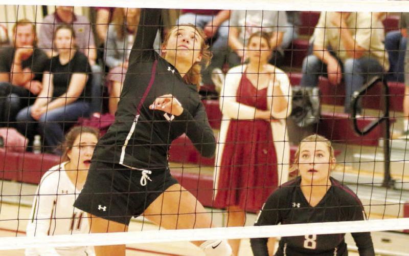 Timber Lake senior middle hitter Shay Kraft hammers a spike toward the Cheyenne-Eagle Butte Lady Braves during their matchup in Timber Lake last Tuesday, Aug. 30. Looking on are Kenna Webb (8) and liberio Abby Linderman (11). Photo by Jon Flatland