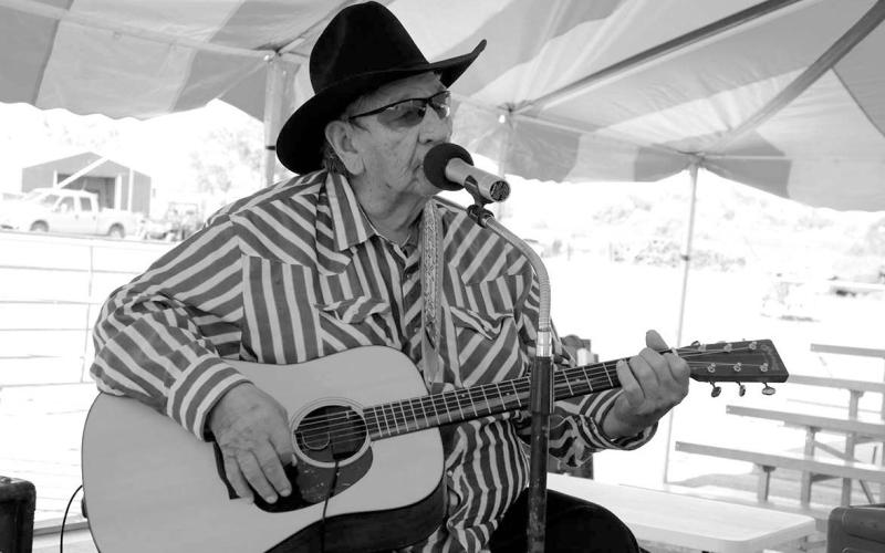 Warming up the audience prior to the Days of 1910 Talent Show under the big tent on Main Street last Thursday, July 24, was White Horse balladeer Frankie Thompson, a favorite among local residents. Thompson sang from his set list and also took requests from the audience. Photo by Jon Flatland