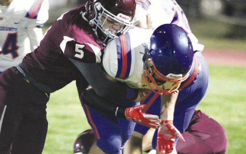 Sophomore Gabe Keller (5) knocks the ball free from a Jones County runner during Timber Lake’s win over the Coyotes last Friday. The Panther defense recorded nine QB sacks, two interceptions and a fumble recovery in the game. Photo by Jon Flatland