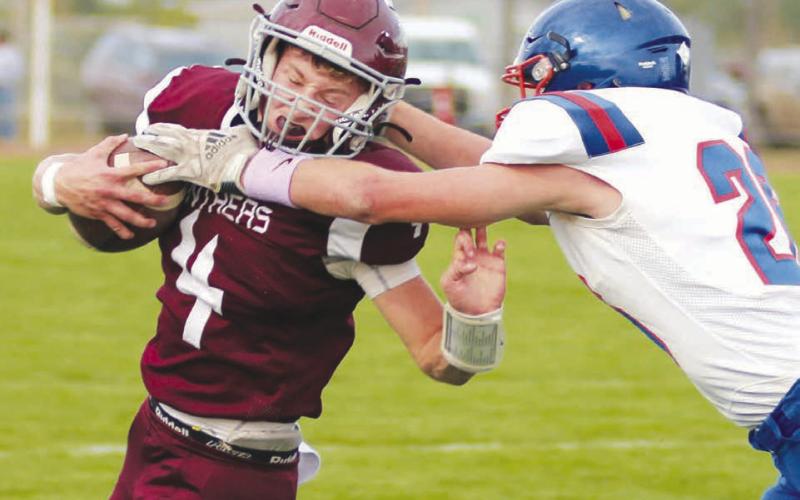 Timber Lake quarterback Gracen Hansen grimaces as he takes a high hit from Jones County linebacker Adrick Schoon during the Panthers 46-6 win over the Coyotes last Friday at Doug Kraft Field. Hansen finished the contest with three touchdown passes to go along with a TD run. Timber Lake, 4-1, travels to Faith to take on the 4-1 Longhorns on Friday, Sept. 23. Photo by Jon Flatland