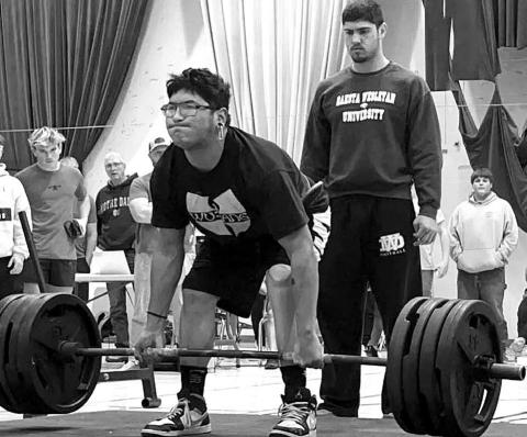 Dupree High School senior Ezekial “Bubba” Marshall attempts a lift at the Mitchell Powerlifting Invitational on Saturday, Dec. 3. Marshall and six other team members turned in lifts that qualified them for the State Powerlifting Meet in March. Photo by Zoey De La Rosa