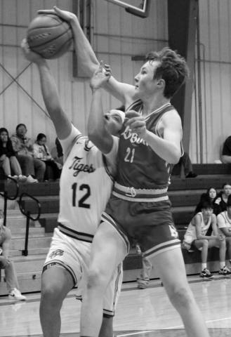 Dupree’s Jeremiah Tiger (12) draws a foul from Bison player Kort Ryan while driving for a lay-up during a meeting between the Tigers and Cardinals last week. Photo by Patty Peacock
