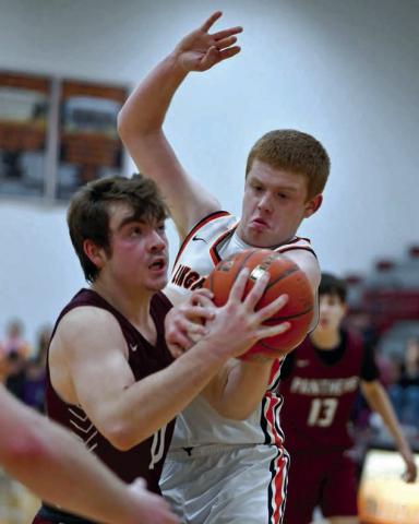 Timber Lake sophomore Treyden Beer (left) eyes the basket while being defended by Faith’s Tace Berglund on a drive into the lane during Little Moreau Conference basketball action last week. Photo by Marie DuPreez