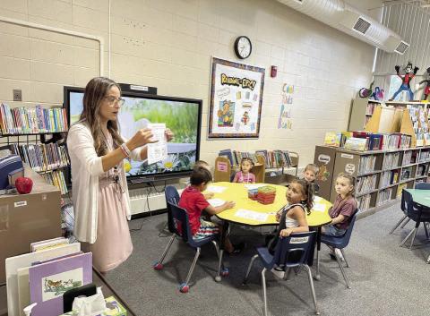 Timber Lake School librarian LeAnn Thompson was ready for students on the first day of school on Monday, Aug. 18. Here she tells Kindergarteners that they can check out books to take home and introduces them to the rules on how to care for books. Photo by Kathy Nelson