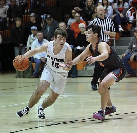 Timber Lake sophomore guard Treyden Beer works the ball upcourt while being harrassed by a Mobridge-Pollock defender during cross-river boys basketball action in Mobridge just before the holiday break. Photo by Marie Du Preez