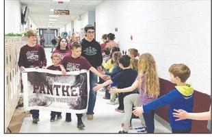 State AAU wrestling qualifiers paraded through the Timber Lake School corridors on Thursday, March 14 to be cheered on by students and staff. Photo by Kathy Nelson