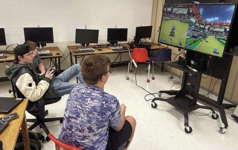 Johnny Hoyt (center) and Evan Schweitzer (right) compete in eSports league games while Nathaniel O’Bryan (far left) looks on. The Timber Lake High School eSports team is wrapping up its first season with playoffs beginning next week.