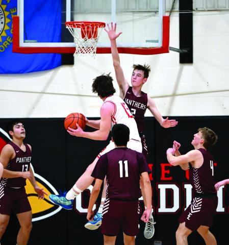 Timber Lake’s Kyler Bollinger (2) uses his 6-2 frame and long reach to defend the basket during recent action against Bison. Looking on and positioning for the blocked shot or rebound are the senior guard’s teammates Aidan Rough Surface (13), Tristan Dupris (11) and Gracen Hansen (4). Bollinger scored 13 points and grabbed a half-dozen rebounds in a 74-34 win over the Cardinals. Photo by Marie DuPreez