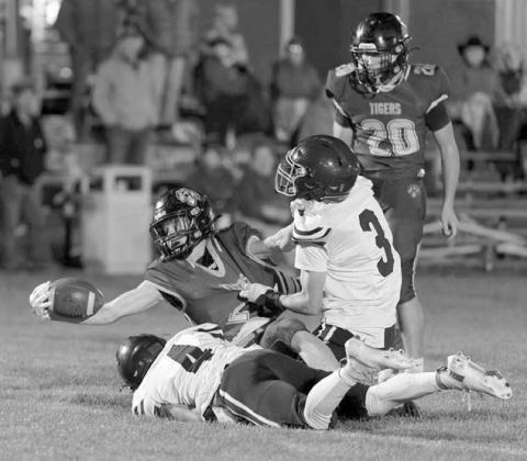 Dupree running back Cruz Birkeland (2) stretches for a first down while being tackled by Timber Lake’s Broc Bauer (4) and Holden Gill (3). Dupree’s Michael Donavon (20) looks on. Birkeland scored two rushing touchdowns in a 38-6 victory over the Panthers last Friday, Oct.17. Photo by Marie DuPreez