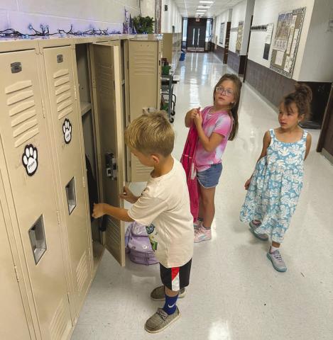 Back to School Finding their new locker is on every student’s checklist on the first day of school. Here Reed Winterberg, Azalea Grage and Lochlyn Goldade find theirs. Photo by Kathy Nelson