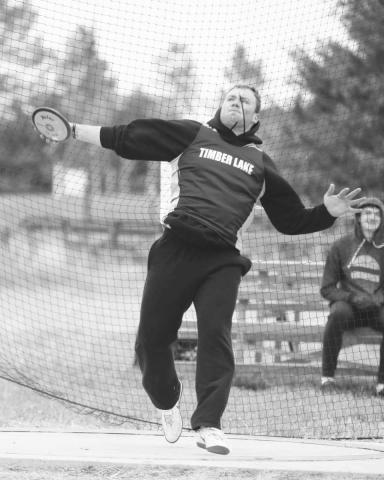 Timber Lake senior AJ Lindskov throws the discus while competing at the Timber Lake Track Invitational at Doug Kraft Field last Tuesday, April 25. Athletes battled cold, gusting winds from the north that put temperatures on the track just above 30 degrees. Lindskov overcame the cold to finish second in the discus with a mark of 105-9 feet.