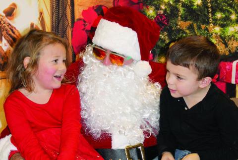 Olive Anderson and Kaysen Smith eagerly shared their Christmas wish lists with Santa Claus during his visit to Dupree for the community’s annual Parade of Lights celebration on Dec. 6. Topic photo by Patty Peacock