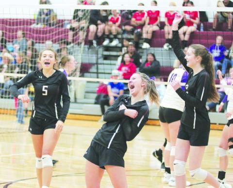 Timber Lake’s Shay Kraft, Carlie Lawrence and Sara Holzer celebrate the winning point in their match against Harding County after overcoming a nine-point deficit in the first round of the Little Moreau Conference Volleyball Tournament played Saturday, Sept. 24, in Faith. Photo by Jon Flatland