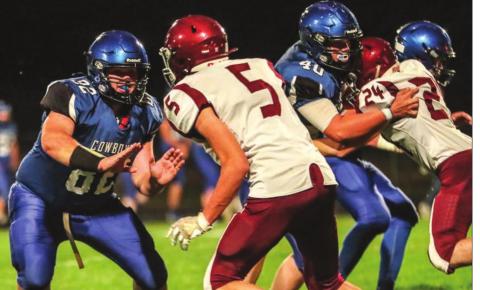 Lemmon/McIntosh linemen Riley Lafferty (82) and Carson Bailey (40) block against Timber Lake’s Trenton Hansen (5) and Konor Lindskov (24) during their 9-man football contest Friday in Lemmon. Photo by Robert Slocum