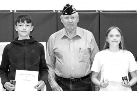 RIGHT: John D. Lemke presented the American Legion 8th Grade Citizenship awards to Walker Farlee and Kyler Hunt.