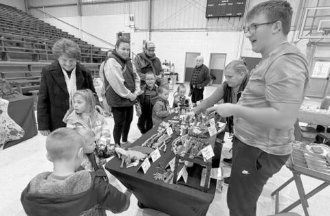 Evan Schweitzer was among the vendors at Isabel’s Holiday Craft Show on Sunday. His spinners and other toys were a huge hit with the kids. Topic photo/Teri Gayer