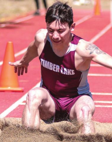 Timber Lake leaper Slater Ducheneaux touches down in the sand pit. File photos by Jon Flatland