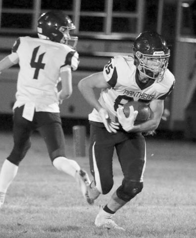 Junior running back Carter Keller looks for running room during Timber Lake’s matchup against Faith last Friday, Sept. 23. Keller picked up 22 yards on six rushing attempts. Photo by Jon Flatland