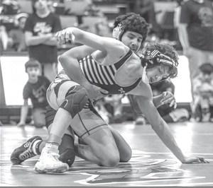 Junior Carmine Crow Ghost tries to work free from an opponent during the 2023 LNI Wrestling Tournament in Rapid City last week. Crow Ghost finished runner-up at 138 pounds. Photo by Robert Slocum